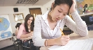 Photograph of a student staring intently at her paper