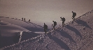 Photograph of people hiking on a sand dune