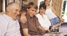 Photograph of several people looking at a photograph album