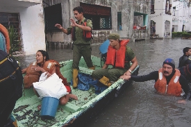 Photograph of people in a boat in a flooded city