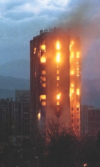 A building in Sarajevo burns after being hit by shells.