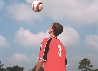 Photograph of a boy watching a ball descending