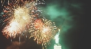 Photograph of firework display in the sky by the Statue of Liberty