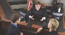 Photograph of a U.S. judge speaking to two attorneys at the bench