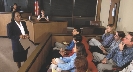 Photograph of a lawyer addressing a jury in a courtroom