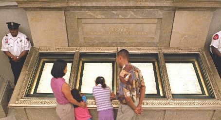 Visitors look at the original Constitution at the National Archives Building in Washington, DC.