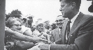 Photograph of Presidential candidate, John F. Kennedy, shaking hands with people in a crowd