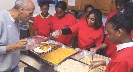 Photograph of young people working at a soup kitchen