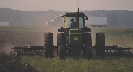 Photograph of farm equipment in use in a field