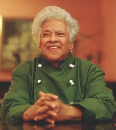 Photograph of a woman in a chef's uniform