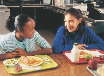 The girls eat lunch together.