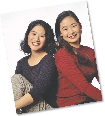 Photograph of two girls sitting side by side