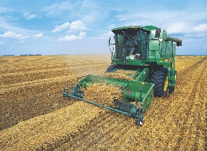 A machine cuts wheat from a field in Iowa. Wheat is a kind of grain.