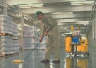 Photograph of a man mopping a floor