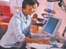 Photograph of a woman at a computer