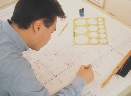 Photograph of a man making an architectural drawing