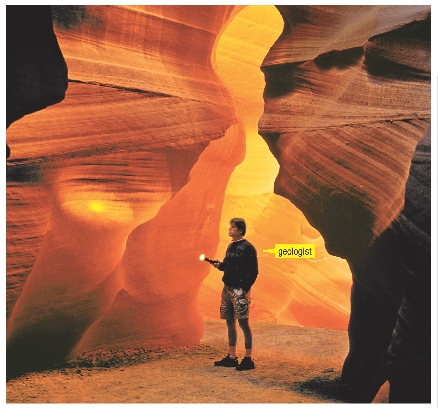 A geologist studies rocks in this cave.