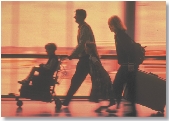 Photograph of a family rushing through an airline terminal with their luggage