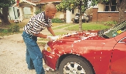 Fred cleans the car.