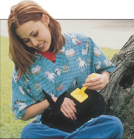 Jo is brushing Velvet the rabbit.