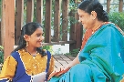 Photograph of an older woman and younger woman smiling at each other