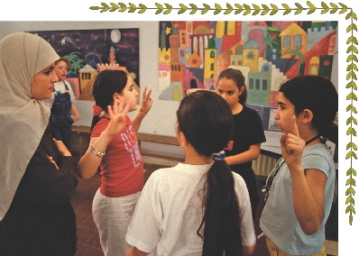 A Palestinian teacher talks with students.