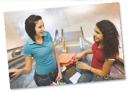 Photograph of two girls on an escalator at a mall