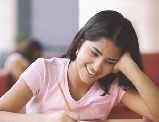 Photograph of girl writing on a piece of paper