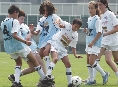 Photograph of children on opposing teams playing a game of soccer