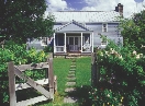 Photograph of a house and front yard