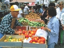 Photograph and people and foods at a farmer's market