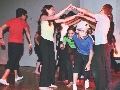 Photograph of a group of children playing a game of “London Bridge”