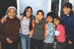 Photograph of an older woman with several grandchildren