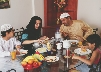 Photograph of a Pakistani family eating together