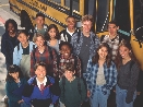 Photograph of a group of students standing outside a school bus