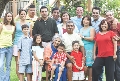 Photograph of a group of people standing close together as if posing for a photograph