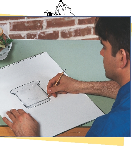 photograph of a male artist sketching a slice of bread