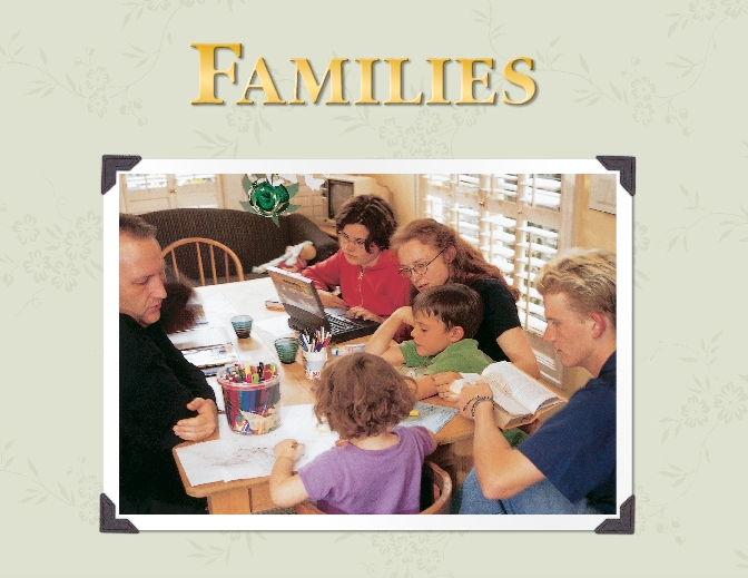 photograph of a family sitting at a table involved in a variety of activities