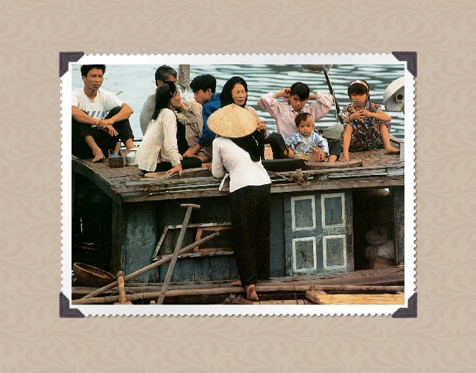 photograph of an Asian family on a boat in a river