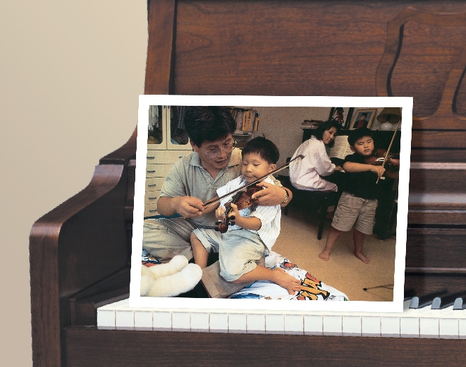 photograph of an Asian family playing piano and violins together