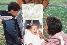 photograph of a father, mother, and baby in a stroller