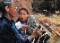 photograph of Native American grandmother weaving and her granddaughter