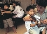 photograph of a family playing piano and violins together