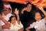 photograph of a Saudi mother, father, and children laughing