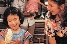 photograph of a woman and a young girl cooking in the kitchen