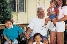 photograph of a mother, father, and children in their home