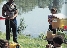 photograph of a family camping next to a lake