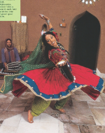 photograph of Afghan woman dancing in traditional dress