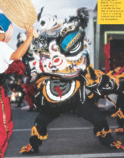 photograph of a person wearing a traditional Chinese lion costume, dancing in the street