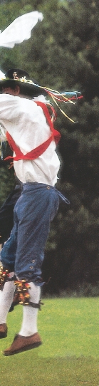 photograph of several young men in traditional English costume, dancing in a park